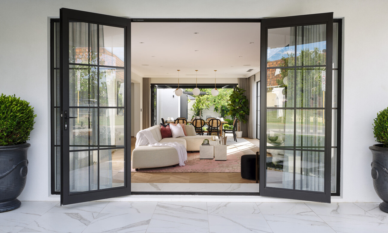 Black-framed French doors opening into a living room